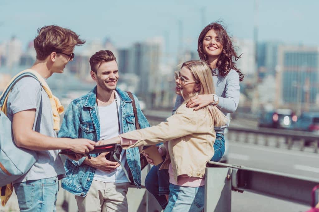 young tourists backpacks map traveling together