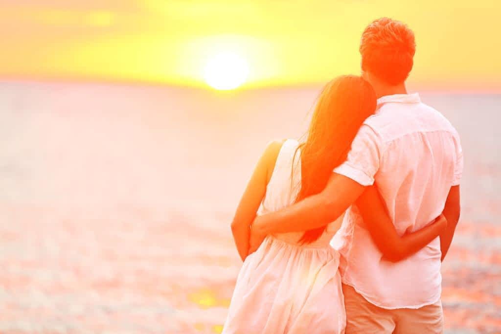 honeymoon couple romantic in love at beach sunset