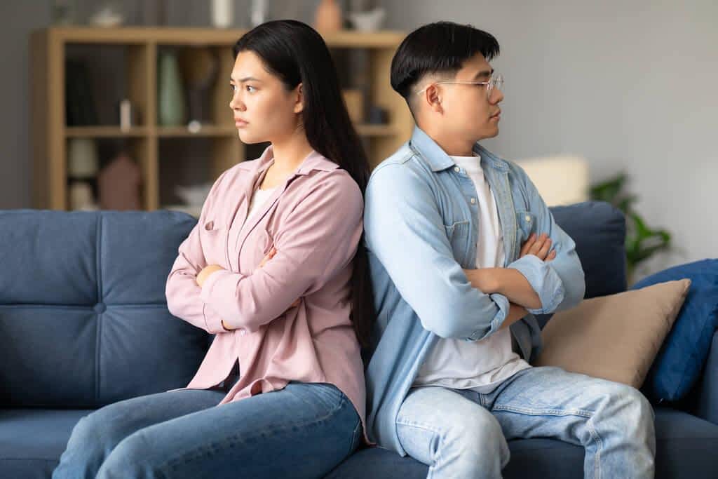 How Indifference in Relationships Can Ruin, or Save It 5 family conflict unhappy asian spouses sitting couch back back sulking