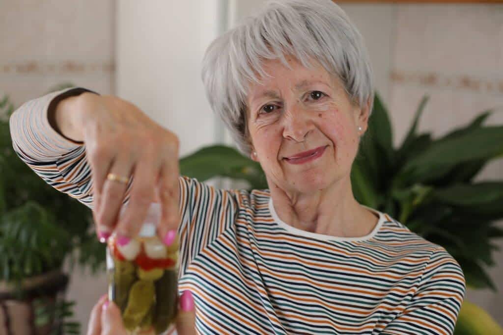 senior woman trying open jar