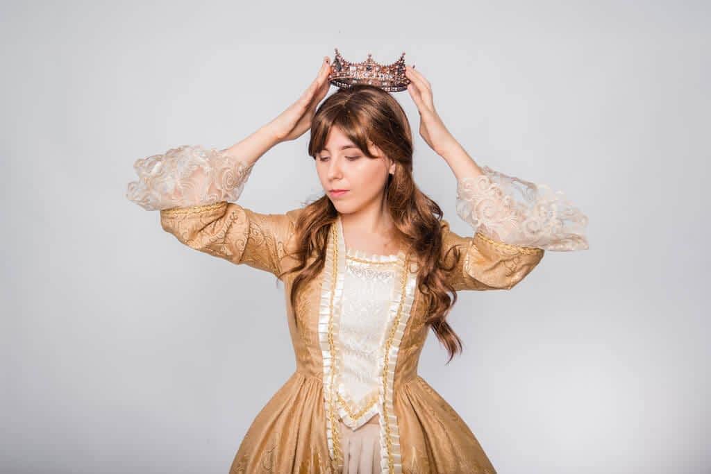 portrait girl golden rococo gown crown his hands posing isolated