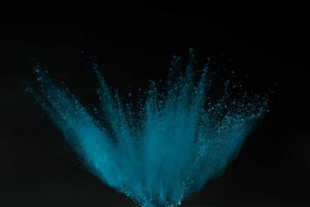 blue holi powder explosion isolated black