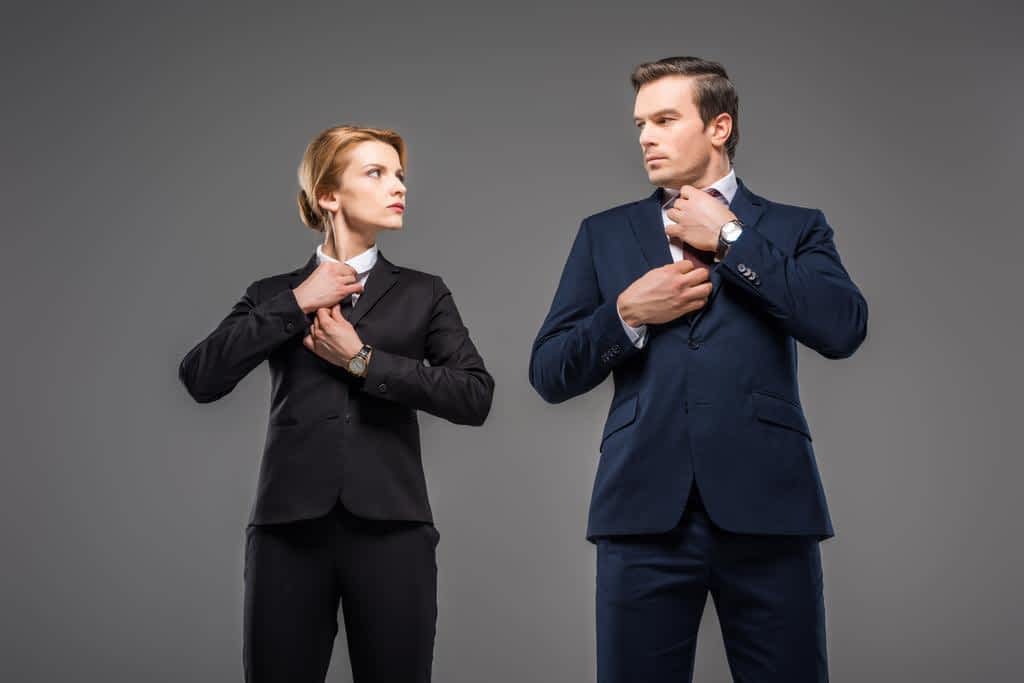 How to Discuss Your Husband's Hygiene Without a Fight 11 serious businesswoman businessman fixing ties