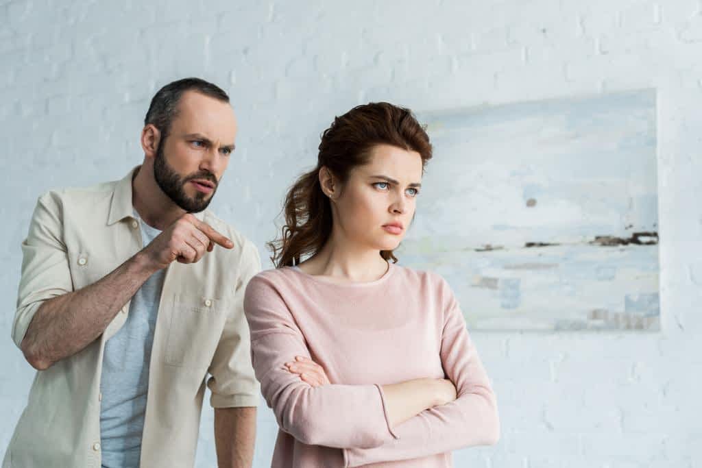 angry man pointing finger upset woman crossed arms