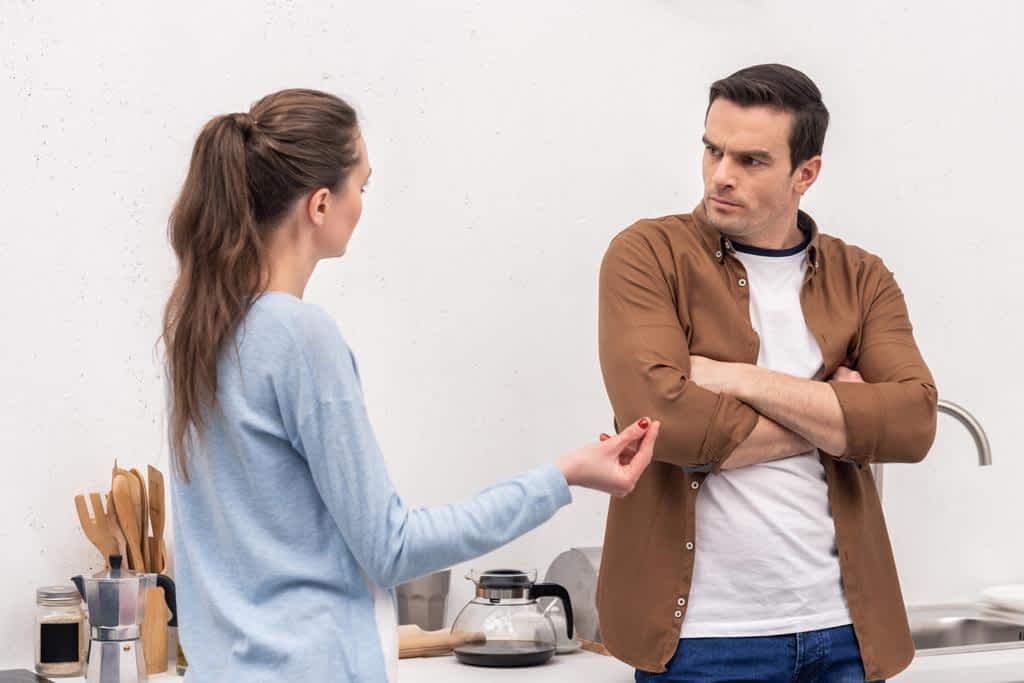 mad adult couple having argument kitchen