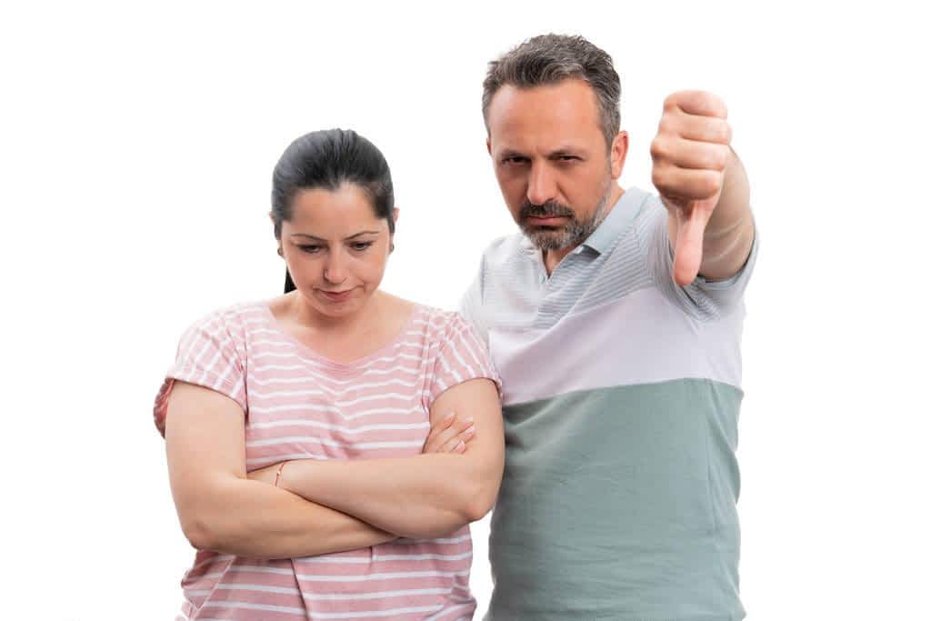 man showing thumb down to upset woman 1