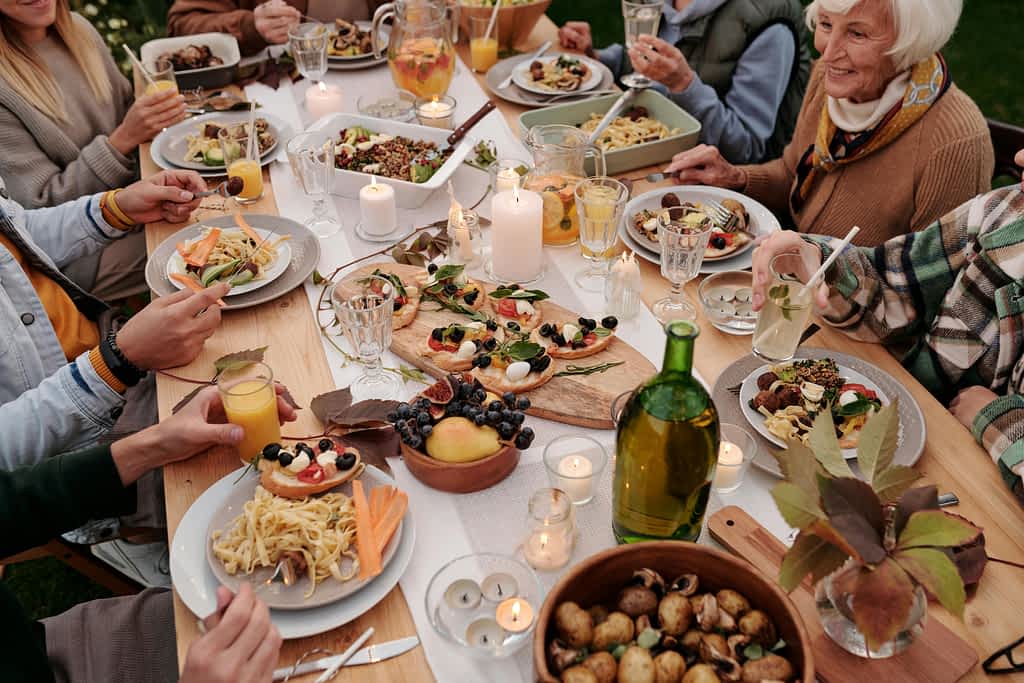 A family eats at a decorated table full of food