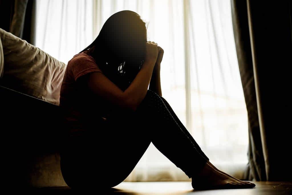 15 Disgusting, Sketchy Things Creepy Men Do 10 silhouette sad scared worried woman sitting dark bedroom stay home