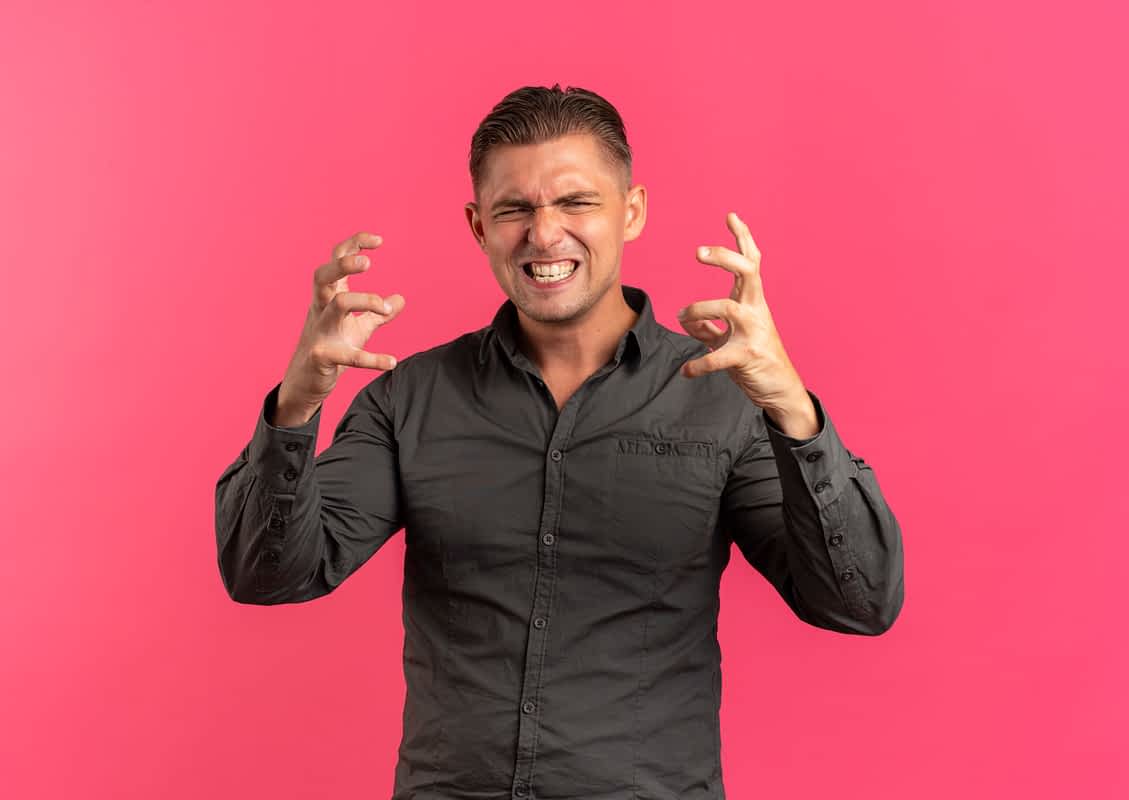 angry man against a pink background