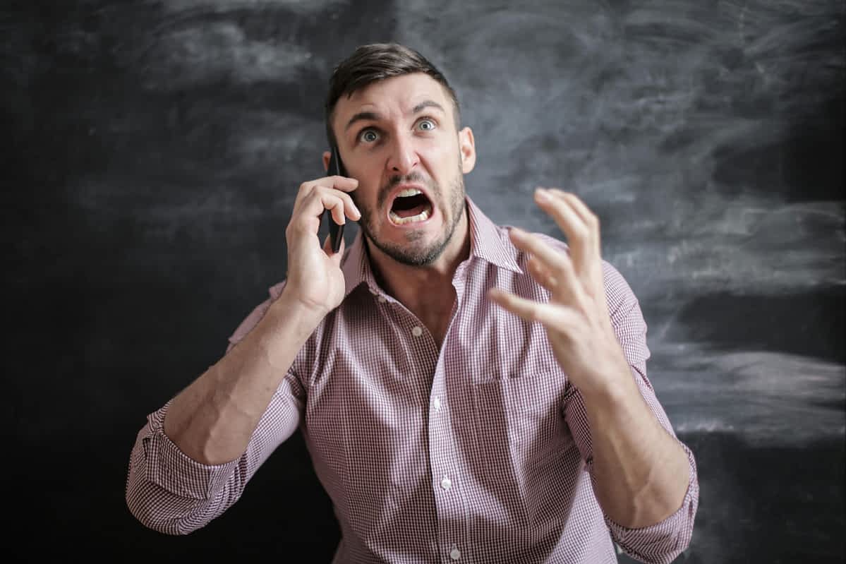 angry man yelling while on the phone