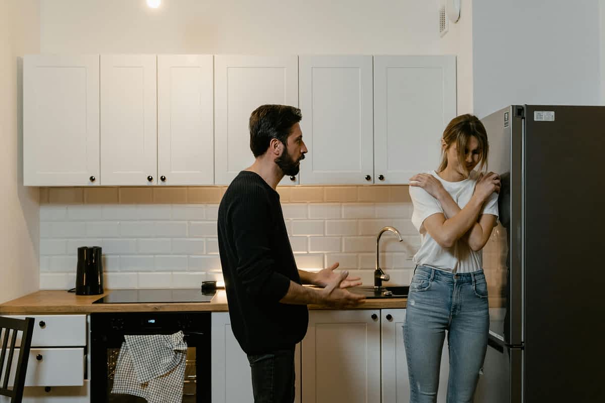 man and woman in an argument in the kitchen