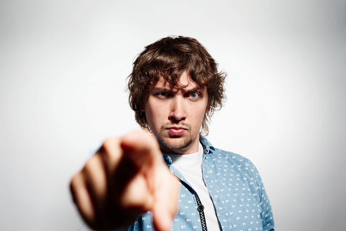 Bitter, angry upset man pointing toward the camera