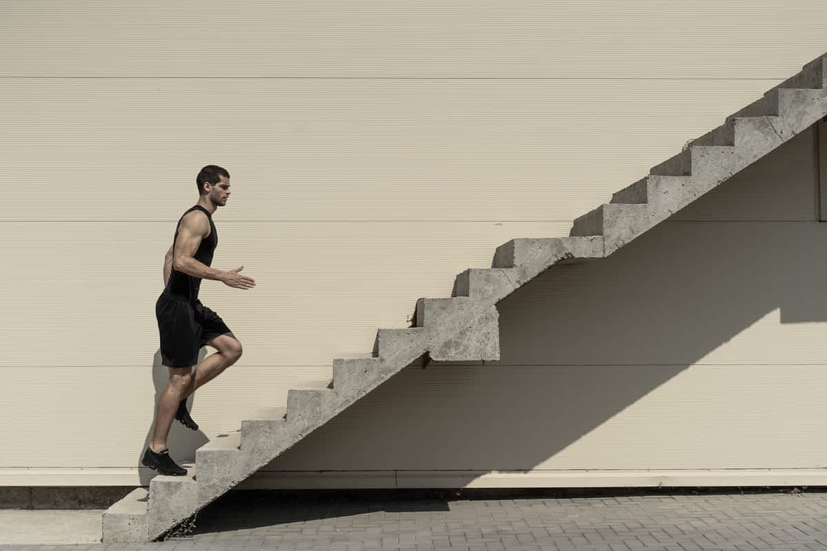 man going up stairs symbolic of how to make a man step up in relationships
