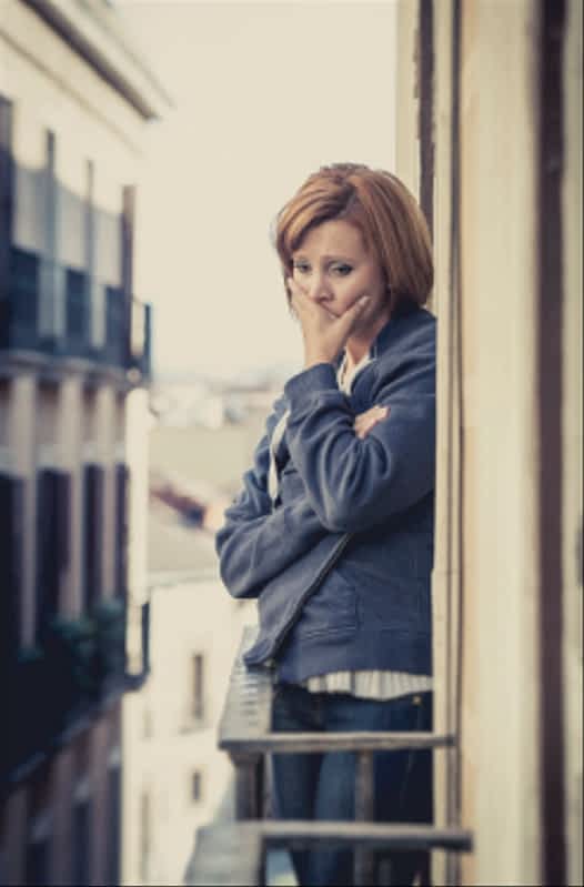 woman suffering depression and stress outdoors at the balcony