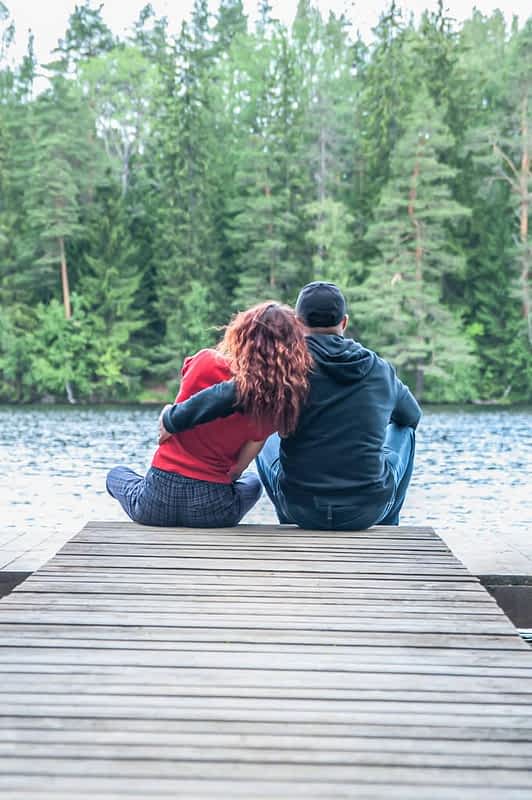 guy girl sit hugging pier beautiful lake love