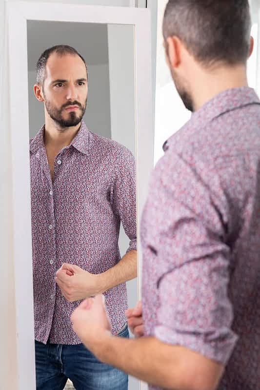 man looking mirror give him self confidence