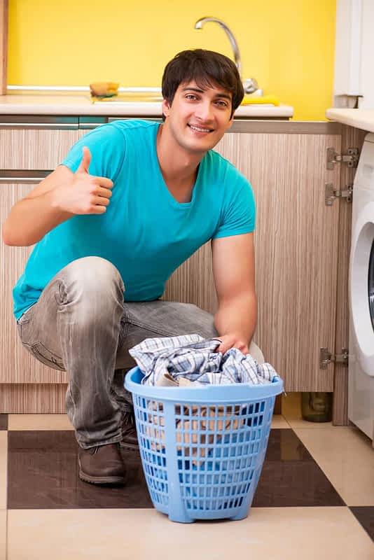 young husband man doing laundry at home