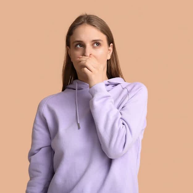 Body Language of Rejection: 6 Physical Signs You Can't Fake 2 woman smelling something bad gross