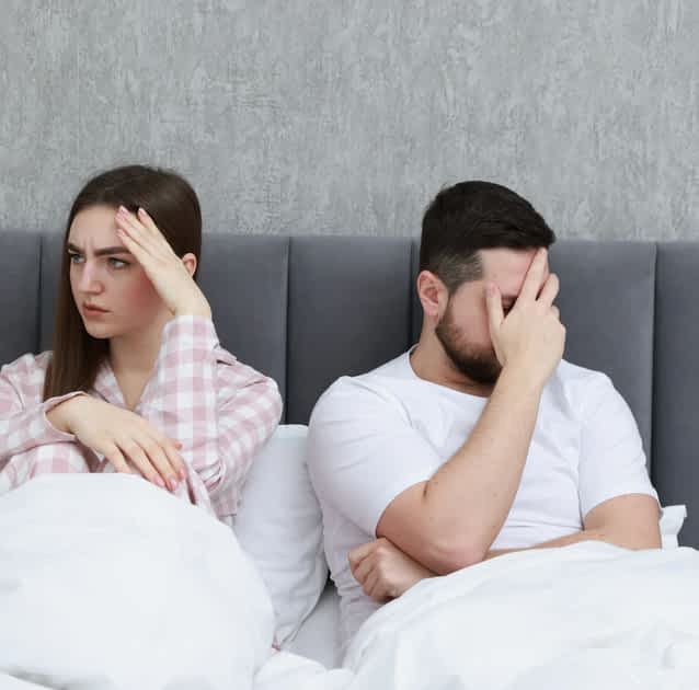 unhappy couple in bed with a dry marriage