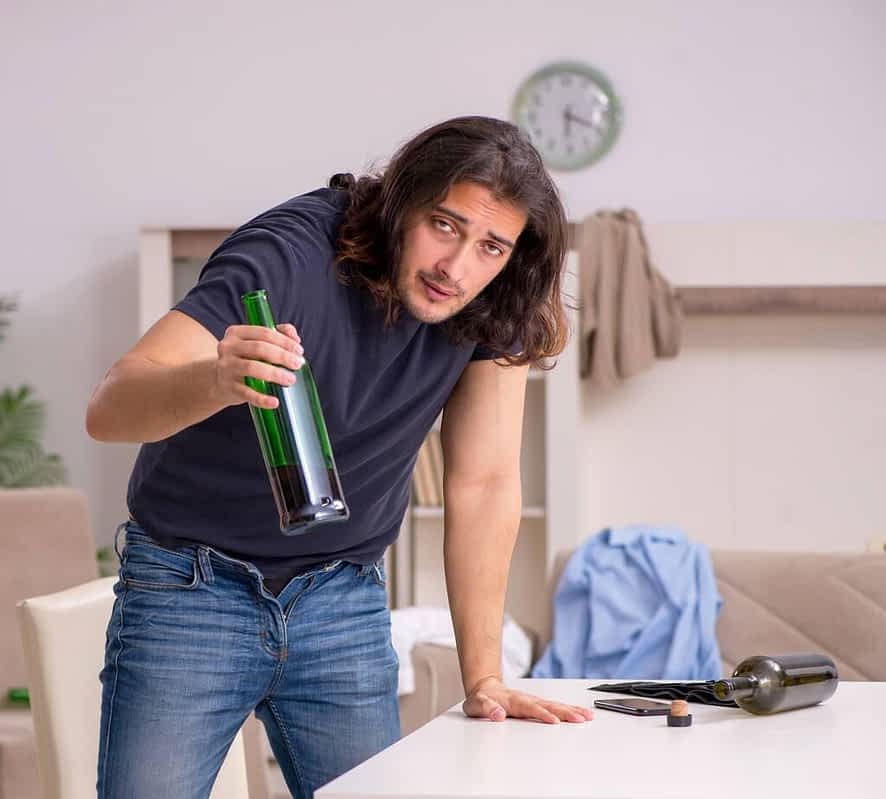 30 Ways to Protect Yourself From an Angry Drunk 5 young man drinking alcohol home
