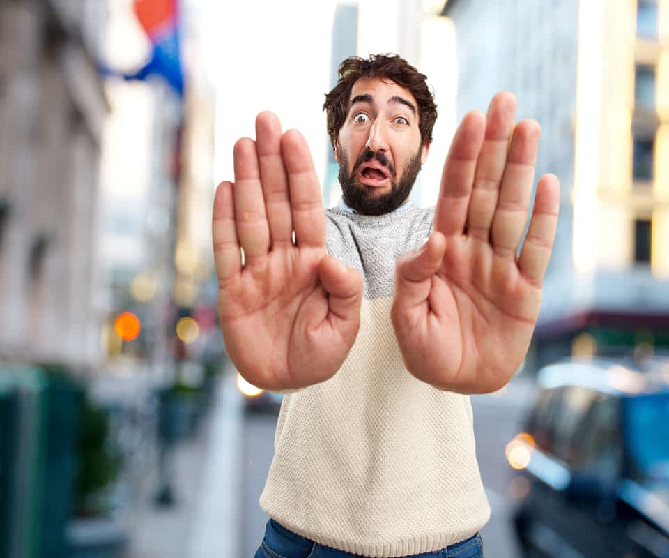 man holding his hands out in a "stop" motion