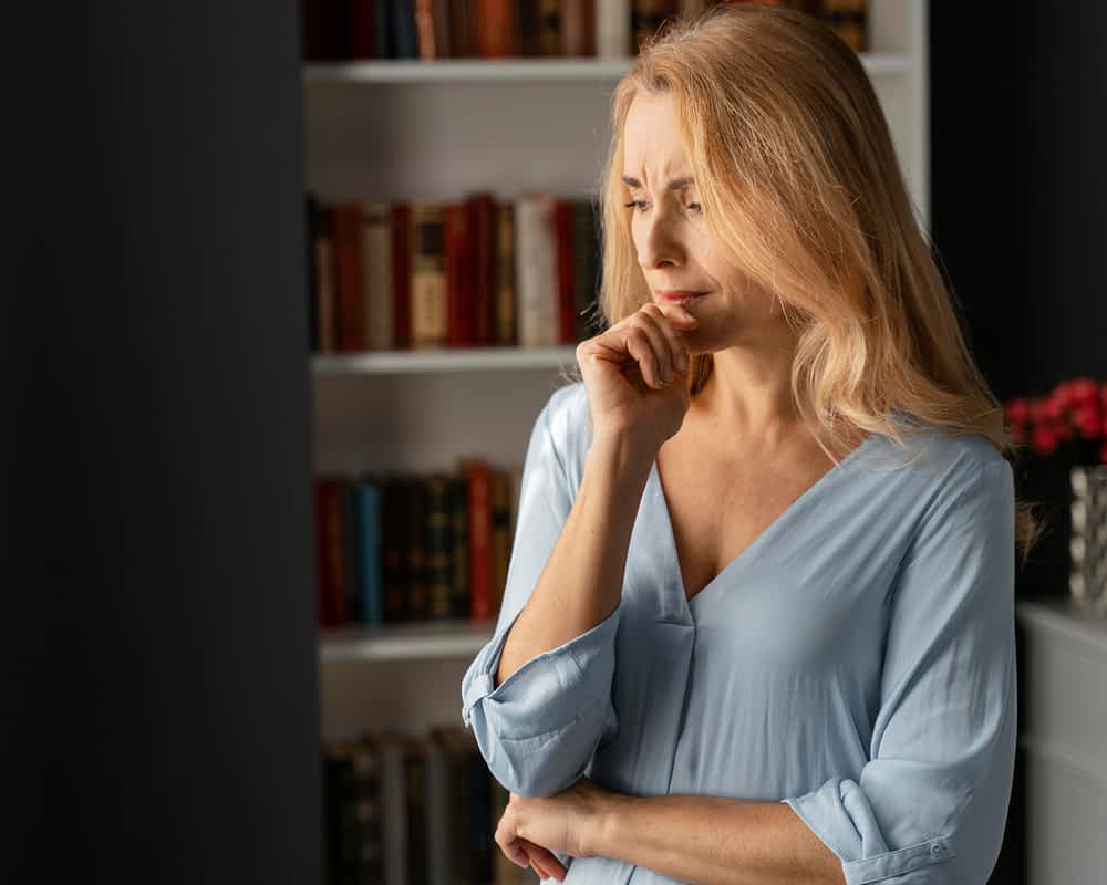 Men Rage Then Act Like Nothing Happened: 7 Chilling Reasons Why 4 Concerned, contemplative senior middle aged woman in a home library