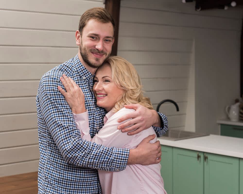 mom and son hugging in kitchen