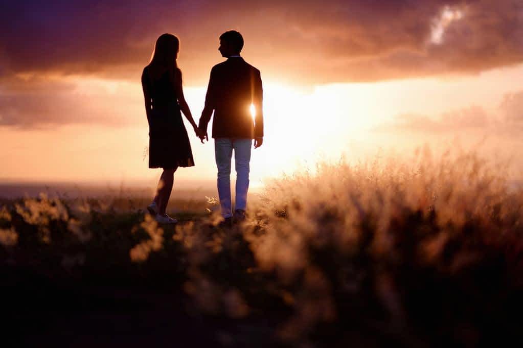 15 Clear Signs You're Not Ready for a Relationship 10 Young couple enjoying the sunset in the meadow