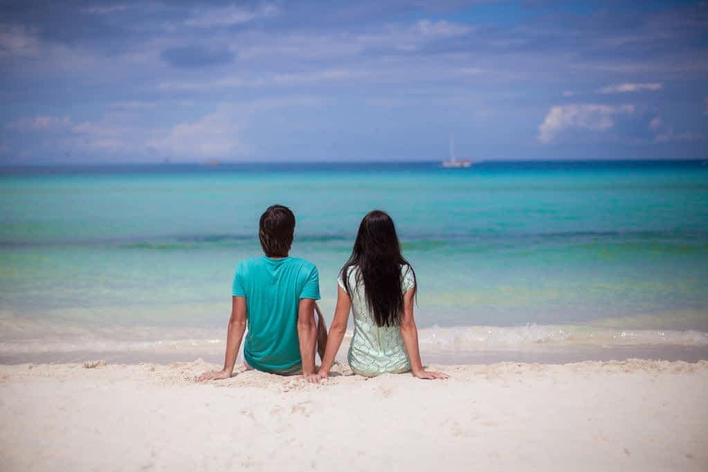 15 Clear Signs You're Not Ready for a Relationship 7 Young couple enjoying each other on sandy white beach
