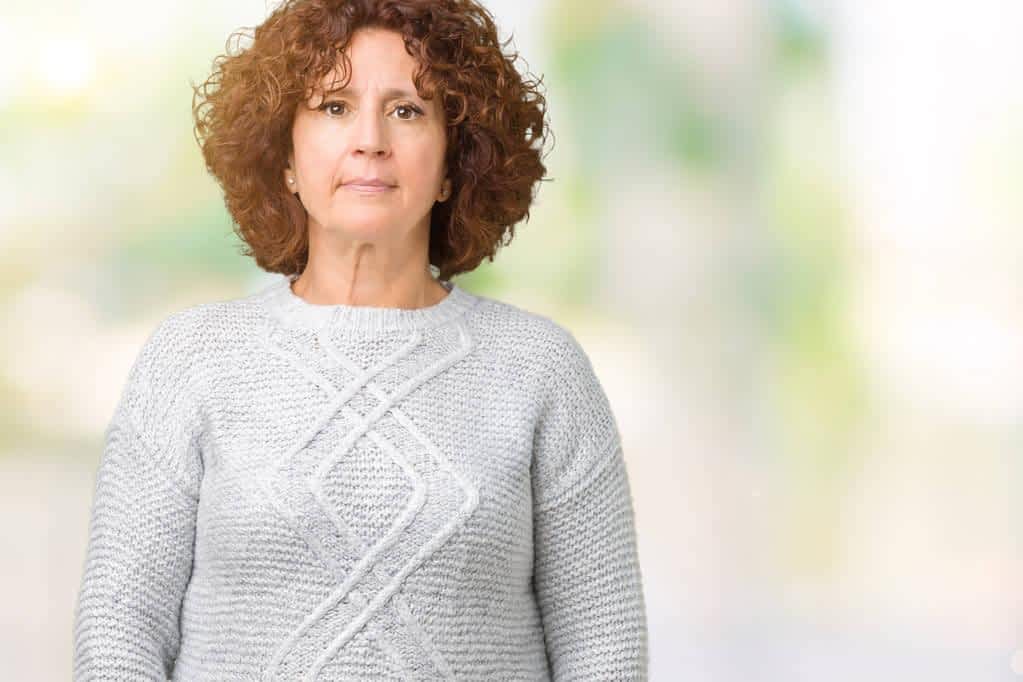 7 Emotional Pitfalls You Need to Avoid During Gray Divorce 9 beautiful middle ager senior woman wearing winter sweater isolated background