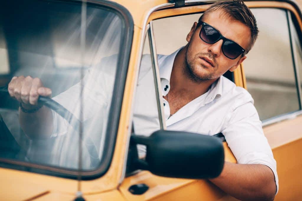 Fragile Masculinity: The Root of Controlling Behavior in Relationships 6 young man behind the wheel of a beautiful appearance retro car