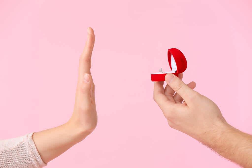 9 Absurd Reasons Why Happily Single Women Trigger Men 3 woman rejecting marriage proposal color background 1