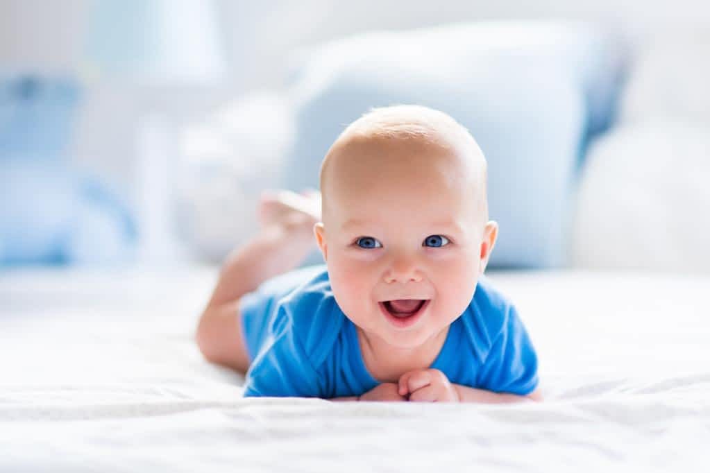baby boy in white sunny bedroom