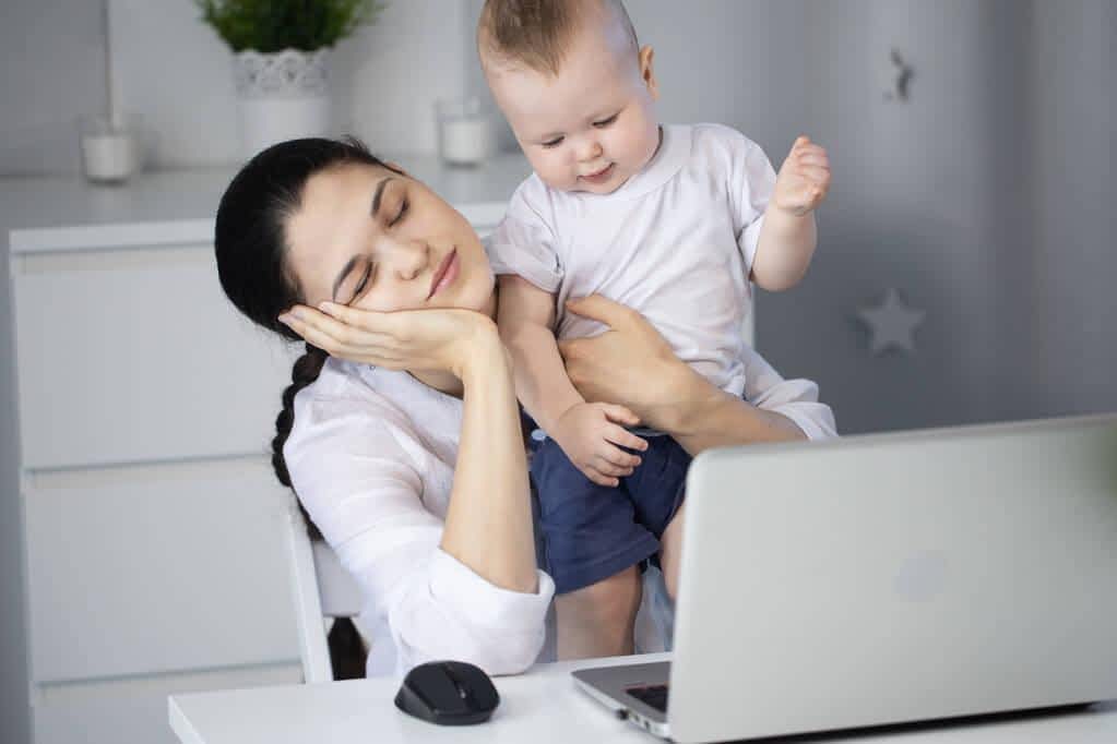 tired sleepy mother tries work capricious child her arms woman