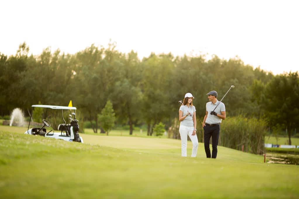 14 Unique Cozy Fall Date Ideas (Not at a Pumpkin Patch) 9 couple at golf course