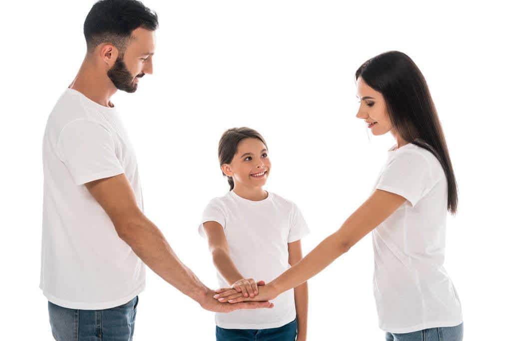 smiling family putting hands together isolated white