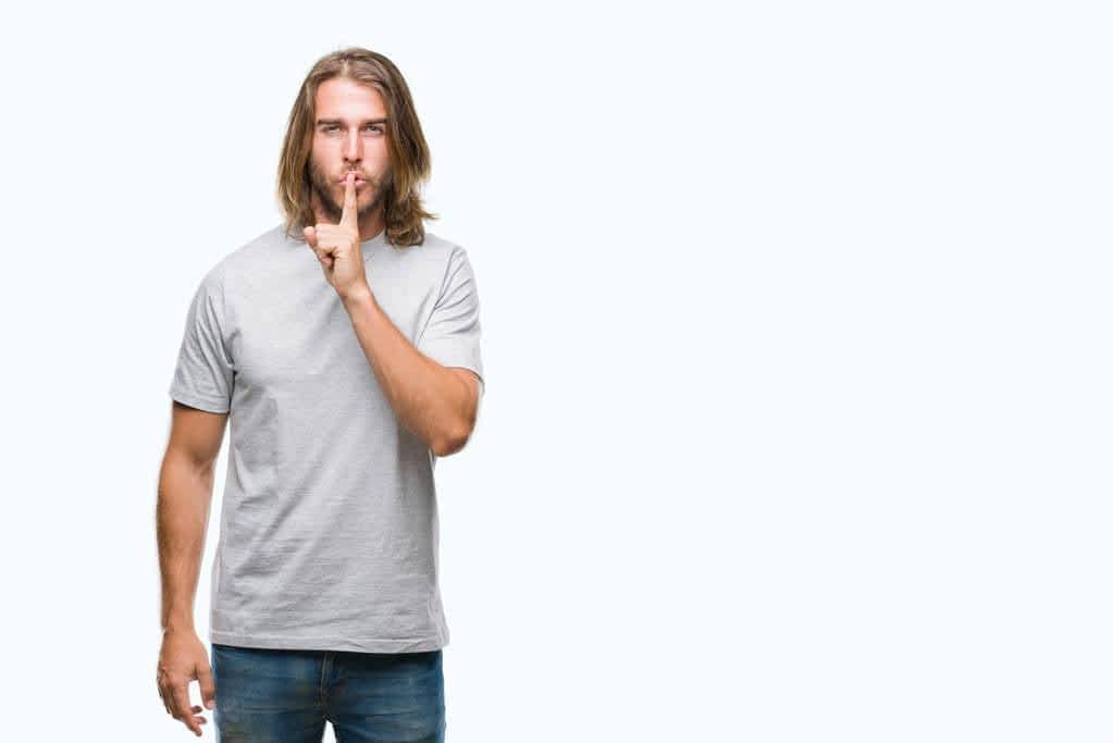 5 Alarming Ways Dark Triad Traits Impact Relationships 3 young handsome man long hair isolated background asking quiet finger