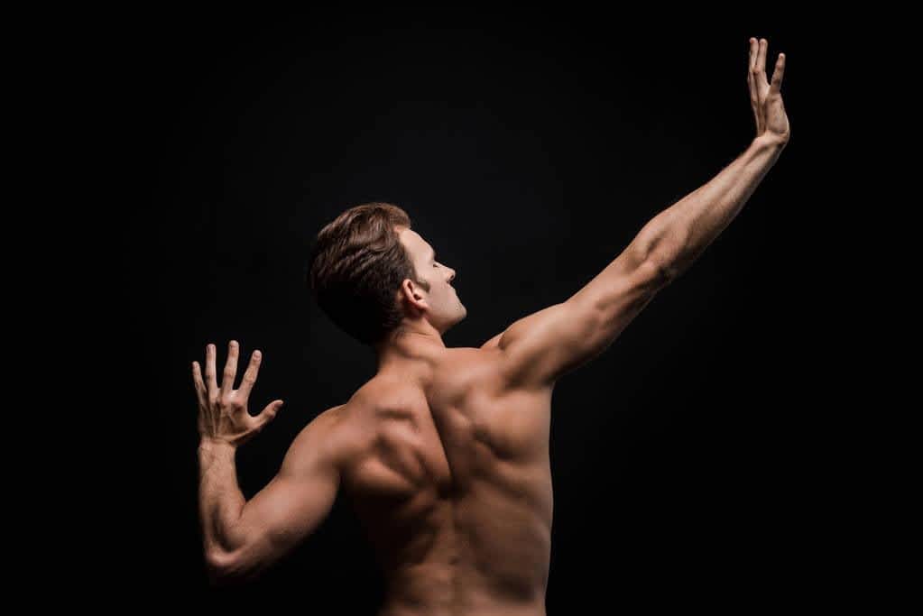 Fragile Masculinity: The Root of Controlling Behavior in Relationships 7 back view sexy shirtless man posing isolated black