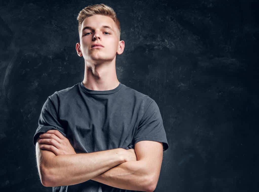 Inside the Narcissistic Mind: 5 Reasons Truth Holds No Value 2 Young arrogant male is looking to the camera crossed his hands over dark background.