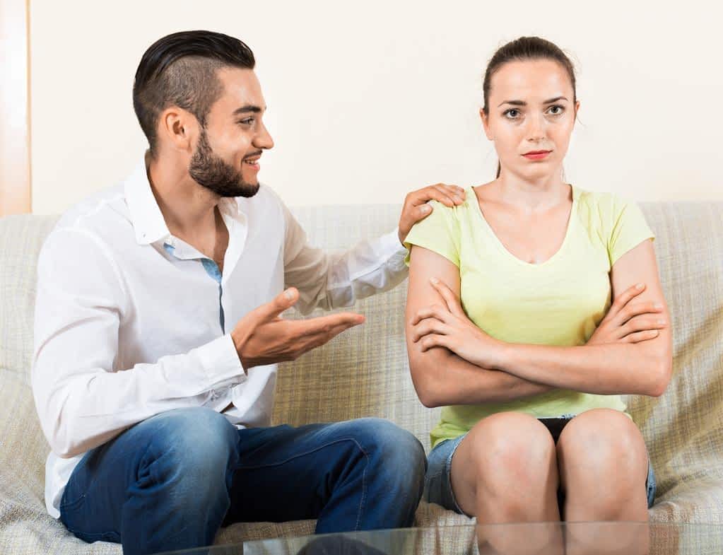 man talking to upset woman