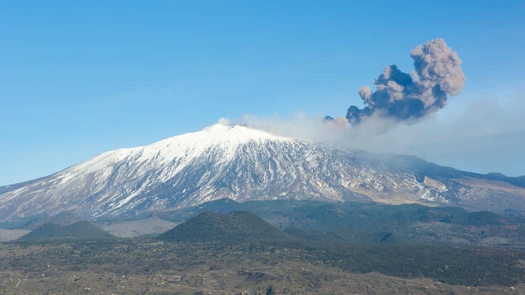 volcano etna and column of smoke