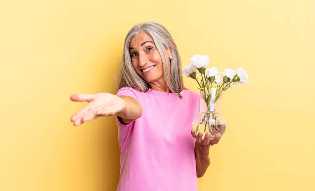 smiling happily friendly confident positive look offering showing object concept