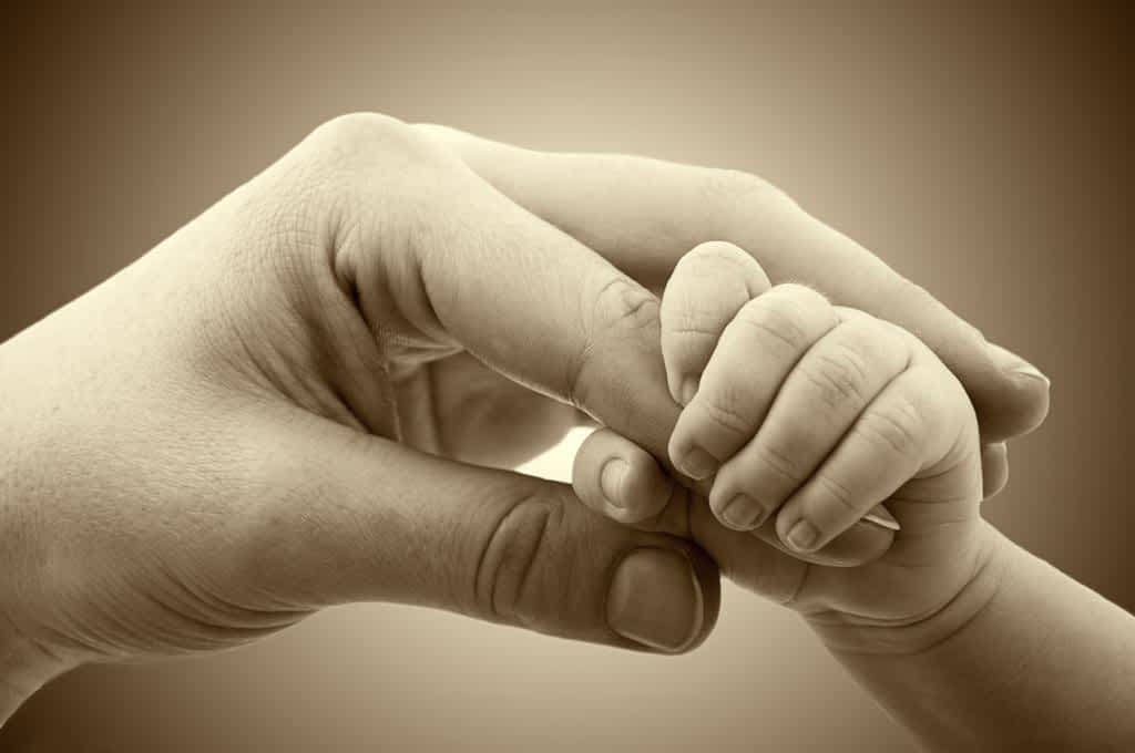 love and family hands of mother and baby