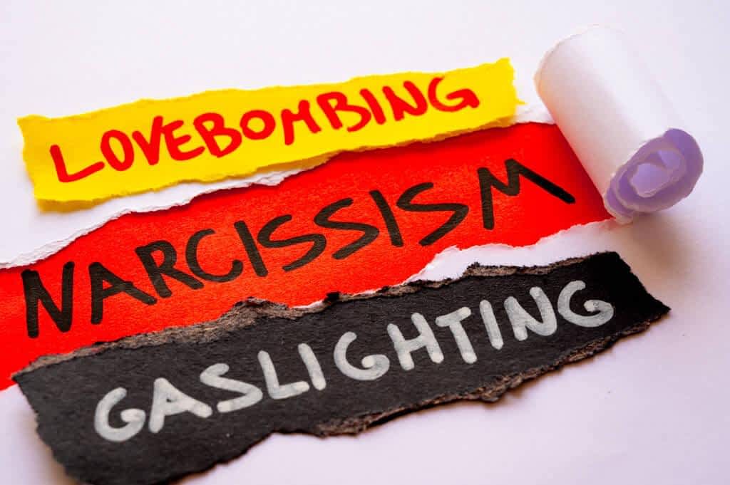 word narcissism red surface torn white sheets alongside cards words 1