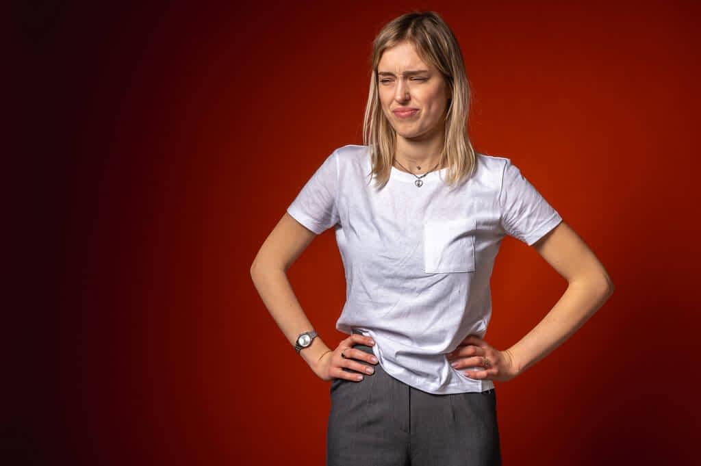 Why Men Mistake Kindness For Flirting 3 young woman white shirt making disgusted facial