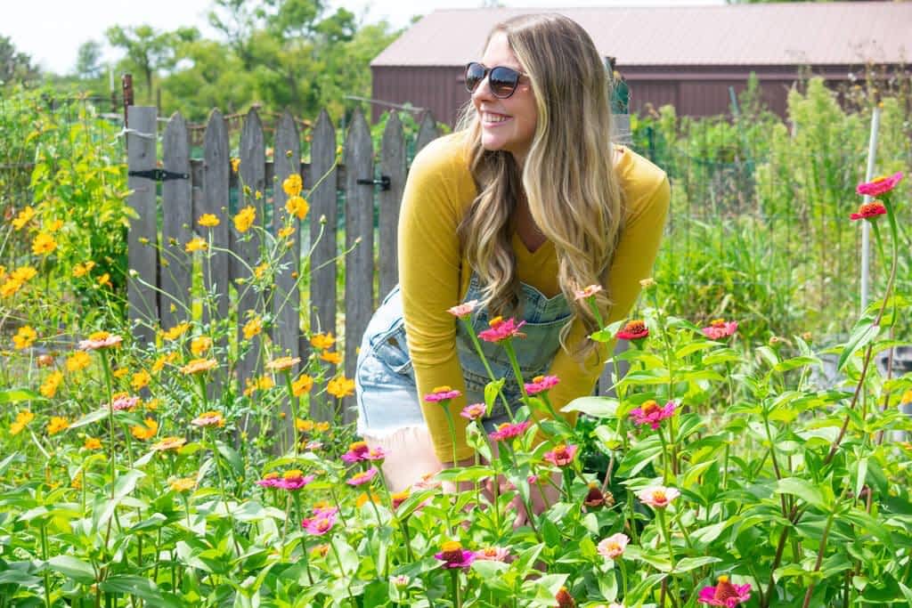 happy young woman working garden summer wearing jean overalls