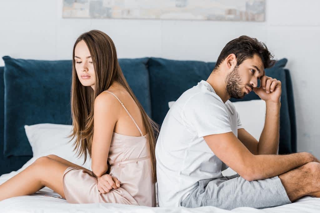 stock photo young depressed couple pajamas sitting bed