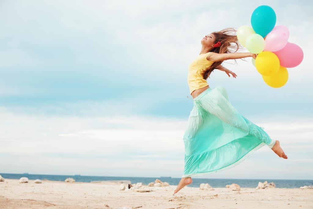 happy girl with bunch of colorful air balloons