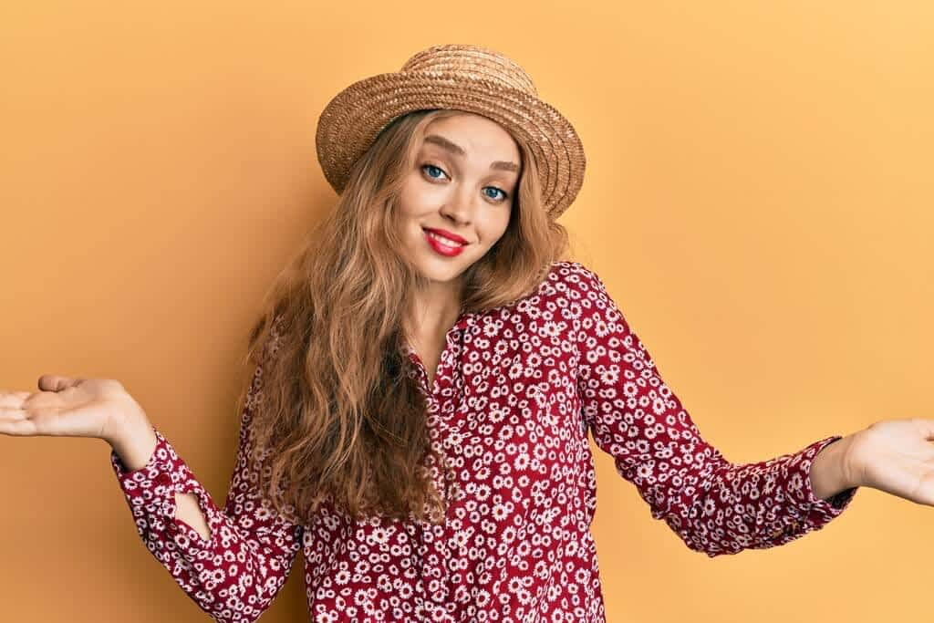 How Indifference in Relationships Can Ruin, or Save It 2 beautiful blonde caucasian woman wearing summer hat clueless confused