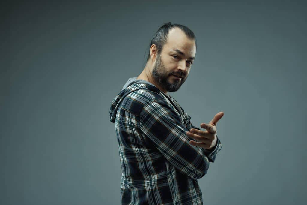 Contempt in Relationships: 5 Eye Opening Examples, Its Disastrous Effects 2 bearded casual man looking camera knowing smile